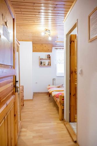 a room with two beds and a hallway at Chata Dolinka Gápel in Valaská Belá