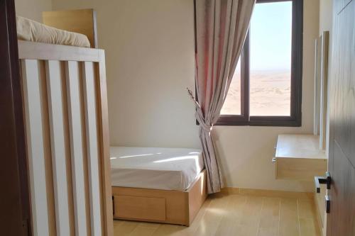 a bedroom with a bunk bed and a window at 2 Bed Chalet Sleeps 4 Free Parking & Balcony in Ain Sokhna