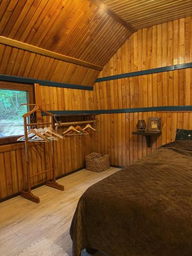 a bedroom with a bed in a wooden cabin at FoRResT in Chynadiyovo