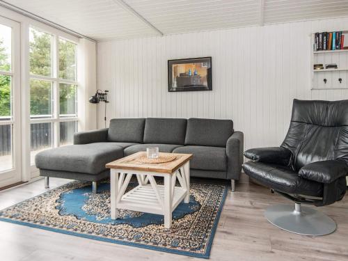 a living room with a couch and a table at 5 person holiday home in Hemmet-By Traum in Falen