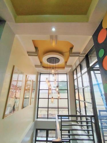 a chandelier hanging from a ceiling in a building at Maya Suites Badian powered by Cocotel in Badian