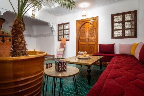 a living room with a couch and a table at Riad Dekkak - Traditional Private Riad in Marrakesh