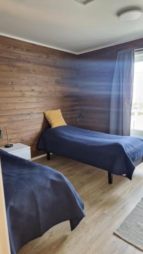 a bedroom with two beds and a window at Jakobselvkaia in Vadsø