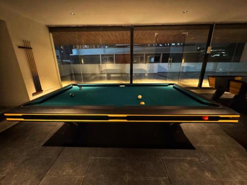 a pool table in the middle of a room at Lux Living Hotel in Bengaluru