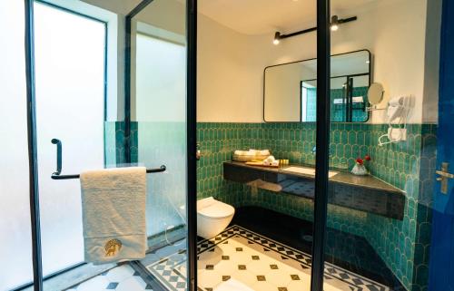 ein Badezimmer mit Toilette, Waschbecken und Spiegel in der Unterkunft Sisodia Bagh Luxury Boutique Resort-Jaipur in Jaipur