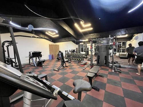 a room with a gym with tread machines and a piano at Comfort Stay Calangute beach Goa in Serula