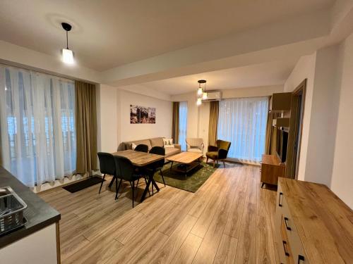 a kitchen and living room with a table and chairs at Titik Apartments Mavrovo in Mavrovo