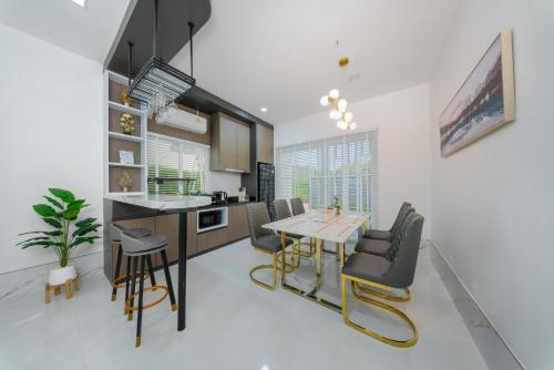 a kitchen and dining room with a table and chairs at Lark Pool Villa Aonang Krabi in Ao Nang Beach