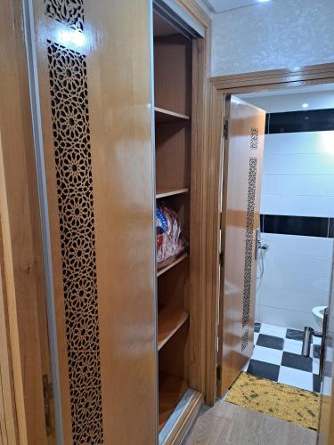 a walk in closet with a glass door in a bathroom at Appartement Au Centre Ville Prés de la Medina in Fez