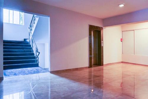 a room with stairs and a stair case at Hotel O EKAB Hospitality in Mundhwa