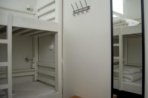 a room with bunk beds and a mirror at Hostel Dalagatan in Stockholm