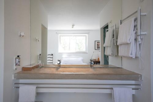 a bathroom with a large sink and a mirror at Casal do Frade in Sesimbra