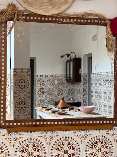 a kitchen with a large mirror on the wall at Berber RIAD with big terrace in Aourir