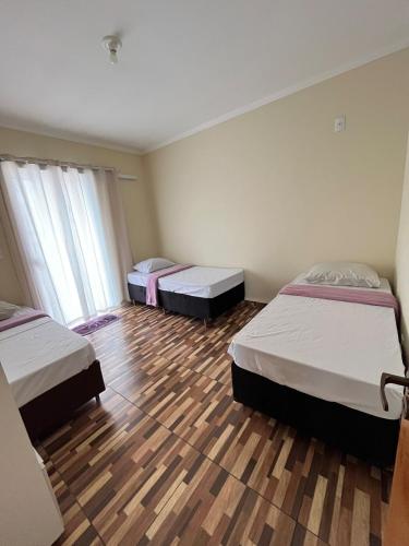 En eller flere senge i et værelse på Apartmento - Poços de Caldas