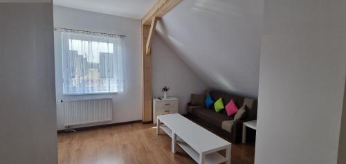 a living room with a couch and a window at Kotwica in Jezierzany