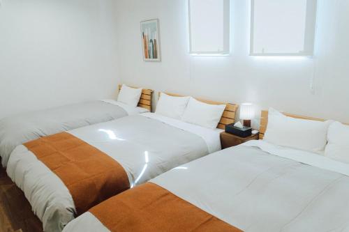 Postel nebo postele na pokoji v ubytování Lohas Resort 芥屋B