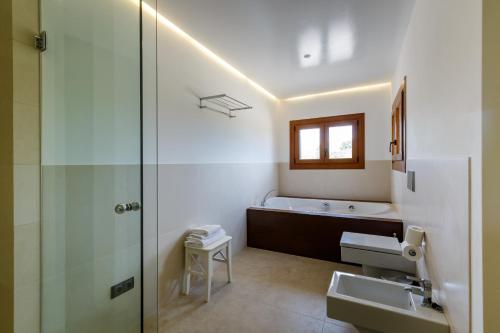 a bathroom with a shower and a sink and a bath tub at Sa Font in Lloret de Vistalegre