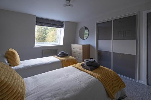 En eller flere senge i et værelse på Park View apartment, Gleneagles Village, Auchterarder