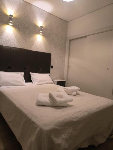 a bedroom with a large bed with two towels on it at Aromas do Vouga in São Pedro do Sul