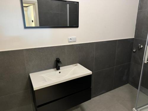 a bathroom with a white sink and a mirror at RRR- Room Rental Rheine in Rheine