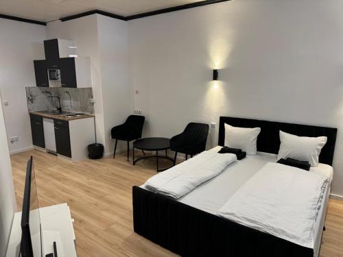 a bedroom with a bed and a table and chairs at RRR- Room Rental Rheine in Rheine