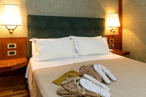 a hotel room with a bed with two towels on it at Grand Hotel Duca D'Este in Tivoli Terme