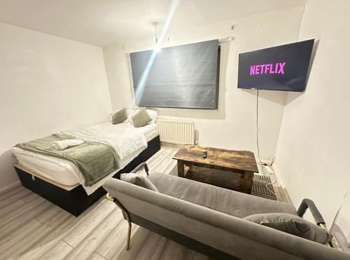 a room with two beds and a sign on the wall at Spacious Double Room By Town Centre in Stevenage