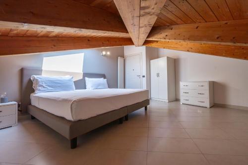 a bedroom with a large bed with a wooden ceiling at NAP Luxury Apartment in Naples