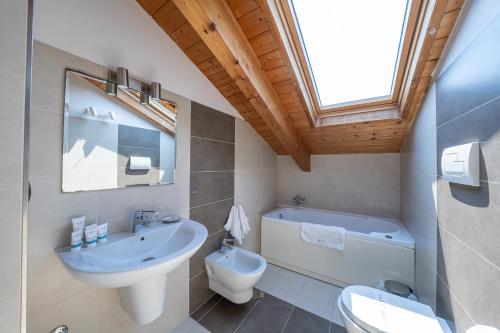 a bathroom with a sink and a toilet and a window at NAP Luxury Apartment in Naples