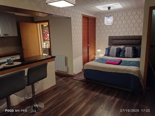 a hotel room with a bed and a desk at Open space studio in Shawlands in Glasgow