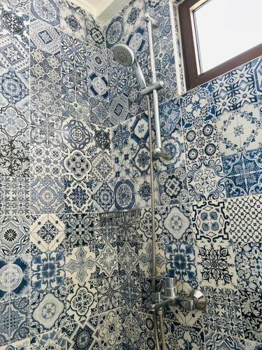 a bathroom with blue and white tiles on the wall at Zaman Ya Zaman Boutique Hotel in Amman