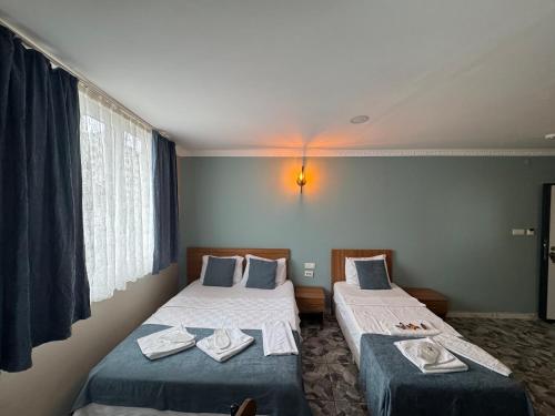 a hotel room with two beds and a window at ERSOY EGE APART OTEL in Antalya