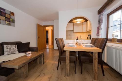 a dining room and living room with a table and chairs at Angelas Appart in Ehrwald