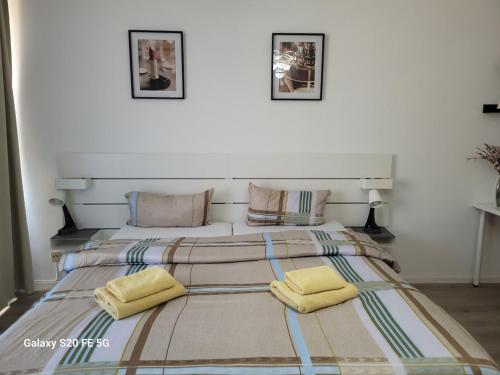 a bedroom with a large bed with two yellow pillows at 3-Zimmer Wohnung in Centrum in Mülheim an der Ruhr