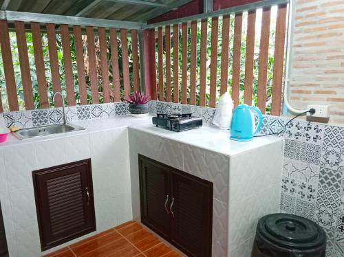a kitchen with a sink and a counter top with a sink at Bo Cabin in Garden โบคาบิน อิน การ์เดน in Ban Nong Ki