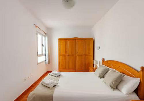 a bedroom with a large white bed and a window at Los Alisios Amplio y luminos a pasos del mar in Pozo Izquierdo