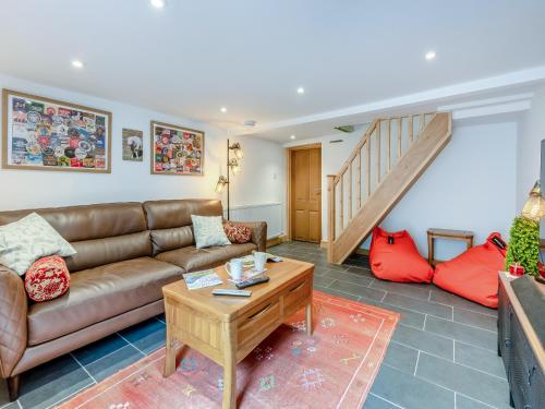 a living room with a couch and a table at Stanley Cottage in Windermere