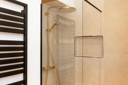 a shower with a glass door and a lamp at Berlin & Friends in Berlin