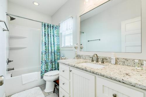 a bathroom with a sink and a toilet and a mirror at Prime Steps to Beach Large Deck Pet Friendly in Stingaree