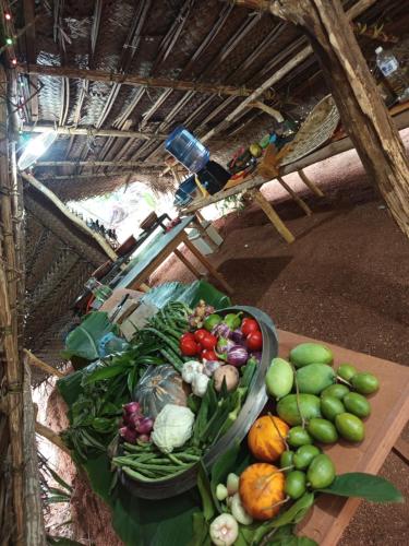 a bunch of fruits and vegetables on a table at SIGIRI HUNTER HOMESTAY Hostel & Guide Room in Sigiriya