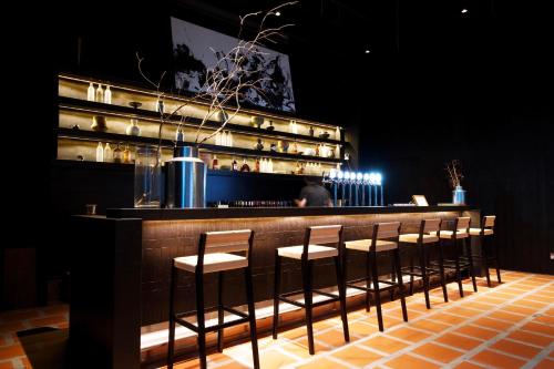 a bar with a row of stools in a restaurant at Shō Hotel Penang in George Town