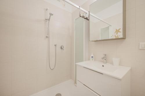 a white bathroom with a shower and a sink at Cervino's Home - 20 min from Venice & Parking in Venice
