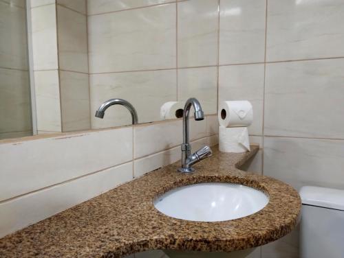 a bathroom with a sink and a toilet at Hotel Brooklin in Sao Paulo