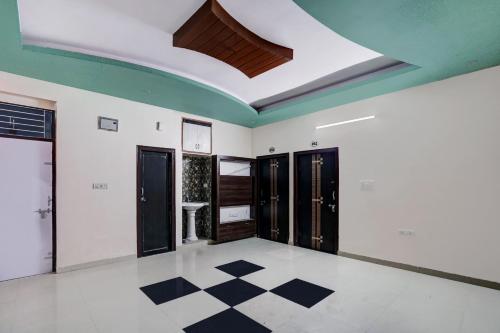 a room with white walls and a ceiling with a checkered floor at Super Hotel O Rudra palace in Jaipur