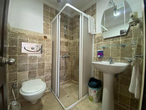 une salle de bain avec une douche, des toilettes et un lavabo dans l'établissement Hotel Alanya, à Alanya