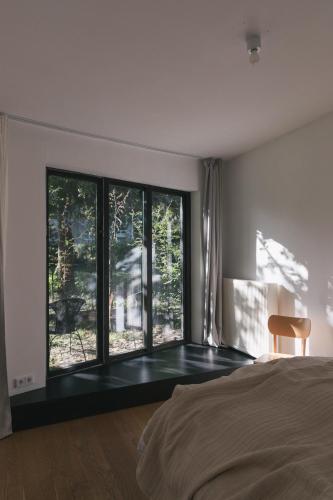 a bedroom with a bed and a large window at Im Scheunhornweg in Werder