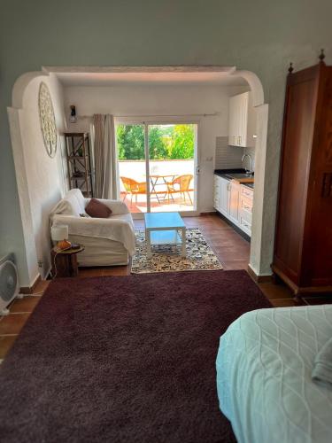 a living room with a couch and a table at Malaka in Coín
