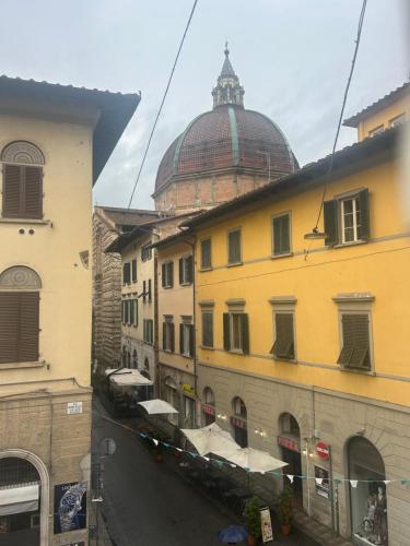 a view of a street with buildings and a dome at AB apartment Pistoia in Pistoia