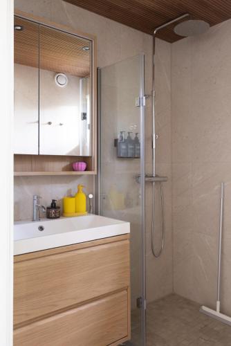 a bathroom with a sink and a shower at Villa MiaEmilia B in Espoo