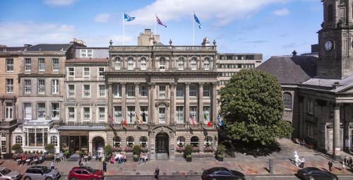 a large building with flags on top of it at InterContinental Edinburgh The George by IHG in Edinburgh